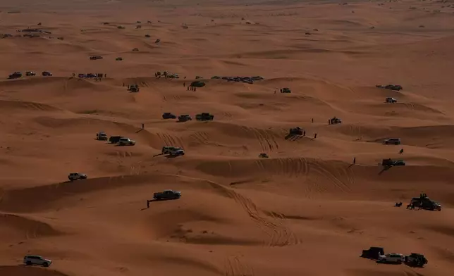 Spectators attend to the sixth stage of the Dakar Rally between Hail and Riyadh, Saudi Arabia, Friday, Jan. 9, 2026. (AP Photo/Thibault Camus)
