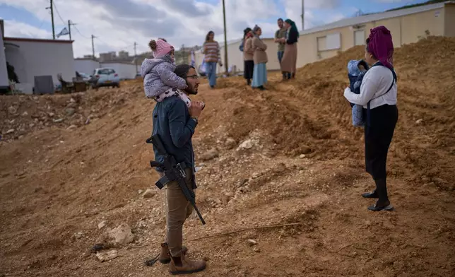Settlers attend the inauguration ceremony for a newly-legalized Jewish settlement, Yatziv, adjacent to the Palestinian town of Beit Sahour, in the West Bank, Jan. 19, 2026. (AP Photo/Ohad Zwigenberg)