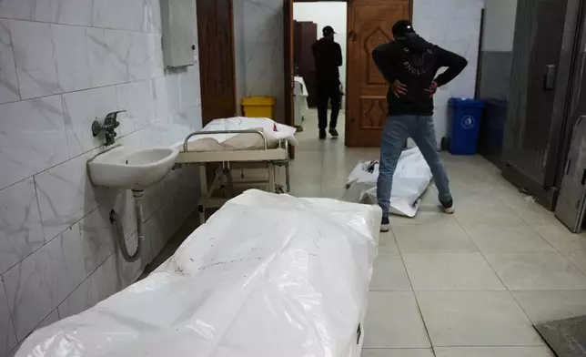 The bodies of Palestinians killed in an Israeli army strike are brought to the morgue at Nasser Hospital in Khan Younis, in the Gaza Strip, Thursday, Jan. 8, 2026. (AP Photo/Abdel Kareem Hana)