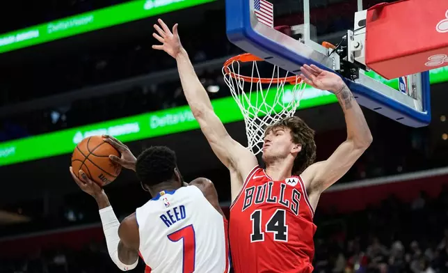 Detroit Pistons forward Paul Reed, left, shoots against Chicago Bulls forward Matas Buzelis during the first half of an NBA basketball game Wednesday, Jan. 7, 2026, in Detroit. (AP Photo/Ryan Sun)