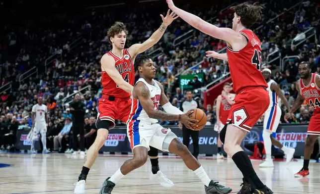 Detroit Pistons guard Marcus Sasser, center, drives against Chicago Bulls forward Matas Buzelis, left, and center Lachlan Olbrich during the first half of an NBA basketball game Wednesday, Jan. 7, 2026, in Detroit. (AP Photo/Ryan Sun)
