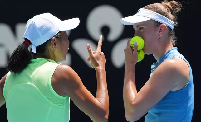 Elise Mertens, right, of Belgium and Zhang Shuai of China in action against Anna Danilina of Kazakhstan and Aleksandra Krunic of Serbia during the women's doubles final at the Australian Open tennis championship in Melbourne, Australia, Saturday, Jan. 31, 2026. (AP Photo/Aaron Favila)