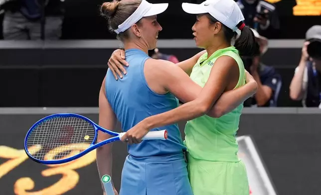 Elise Mertens of Belgium and Zhang Shuai, right, of China celebrate after defeating Anna Danilina of Kazakhstan and Aleksandra Krunic of Serbia in the women's doubles final at the Australian Open tennis championship in Melbourne, Australia, Saturday, Jan. 31, 2026.. (AP Photo/Asanka Brendon Ratnayake)