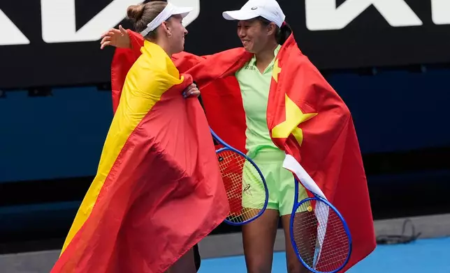 Elise Mertens of Belgium and Zhang Shuai, right, of China celebrate after defeating Anna Danilina of Kazakhstan and Aleksandra Krunic of Serbia in the women's doubles final at the Australian Open tennis championship in Melbourne, Australia, Saturday, Jan. 31, 2026. (AP Photo/Asanka Brendon Ratnayake)