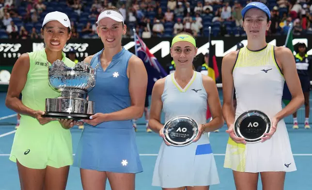 Elise Mertens of Belgium and Zhang Shuai, left, of China pose with their trophy after defeating Anna Danilina, right, of Kazakhstan and Aleksandra Krunic of Serbia in the women's doubles final at the Australian Open tennis championship in Melbourne, Australia, Saturday, Jan. 31, 2026. (AP Photo/Aaron Favila)