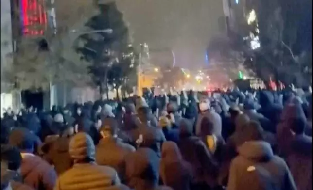 In this frame grab from footage circulating on social media from Iran showed protesters once again taking to the streets of Tehran despite an intensifying crackdown as the Islamic Republic remains cut off from the rest of the world in Tehran, Iran, Saturday Jan. 10, 2026. (UGC via AP)