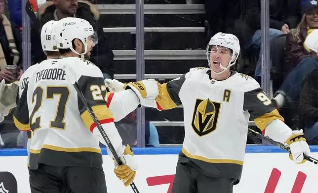 Vegas Golden Knights' Shea Theodore (27), Pavel Dorofeyev (16) and Mitch Marner (93) celebrate a goal against the Toronto Maple Leafs during the second period of an NHL hockey game in Toronto on Friday, Jan. 23, 2026. (Nathan Denette/The Canadian Press via AP)