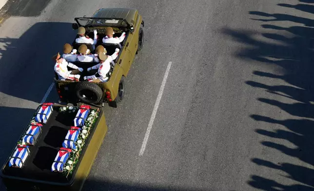 A motorcade transports urns containing the remains of Cuban officers, who were killed during the U.S. operation in Venezuela that captured Venezuelan President Nicolas Maduro, through Havana, Cuba, Thursday, Jan. 15, 2026. (AP Photo/Ramon Espinosa)