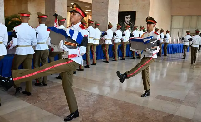 Soldiers carry urns containing the remains of Cuban officers, who were killed during the U.S. operation in Venezuela that captured Venezuelan President Nicolas Maduro, at the Ministry of the Revolutionary Armed Forces in Havana, Cuba, Thursday, Jan. 15, 2026. (Adalberto Roque /Pool Photo via AP)