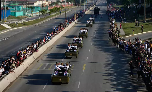 A motorcade transports urns containing the remains of Cuban officers, who were killed during the U.S. operation in Venezuela that captured Venezuelan President Nicolas Maduro, through Havana, Cuba, Thursday, Jan. 15, 2026. (AP Photo/Ramon Espinosa)