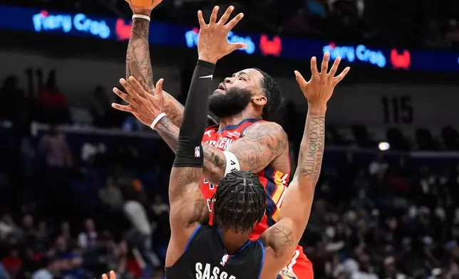 New Orleans Pelicans guard Saddiq Bey shoots against Detroit Pistons guard Marcus Sasser (25) in the first half of an NBA basketball game, Wednesday, Jan. 21, 2026, in New Orleans. (AP Photo/Gerald Herbert)