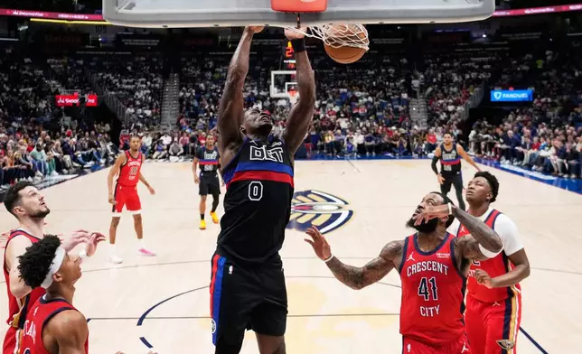 Detroit Pistons center Jalen Duren (0) slam dunks against the New Orleans Pelicans in the first half of an NBA basketball game, Wednesday, Jan. 21, 2026, in New Orleans. (AP Photo/Gerald Herbert)