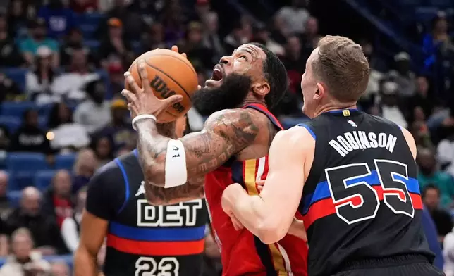 New Orleans Pelicans guard Saddiq Bey goes to the basket between Detroit Pistons guard Jaden Ivey (23) and forward Duncan Robinson (55) in the first half of an NBA basketball game, Wednesday, Jan. 21, 2026, in New Orleans. (AP Photo/Gerald Herbert)