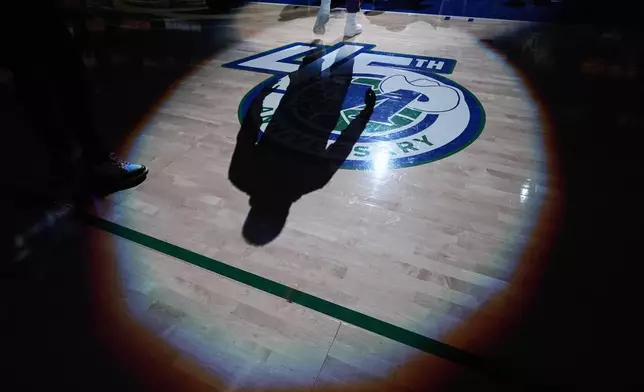 The shadow of Los Angeles Lakers guard Luka Doncic is visible on the court during player introductions prior to an NBA basketball game between the Dallas Mavericks and Lakers Saturday, Jan. 24, 2026, in Dallas. (AP Photo/Julio Cortez)