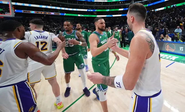 Los Angeles Lakers guard Luka Doncic, right, talks to Dallas Mavericks guard Klay Thompson following an NBA basketball game Saturday, Jan. 24, 2026, in Dallas. (AP Photo/Julio Cortez)