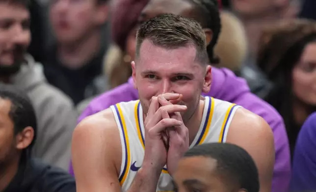 Los Angeles Lakers guard Luka Doncic reacts on the bench during the first half of an NBA basketball game against the Dallas Mavericks Saturday, Jan. 24, 2026, in Dallas. (AP Photo/Julio Cortez)