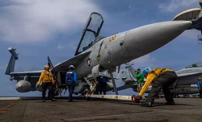 This photo provided by the U.S. Navy shows sailors preparing a Boeing EA-18G Growler on the flight deck of the Nimitz-class aircraft carrier USS Abraham Lincoln in the Indian Ocean on Jan. 21, 2026. (Mass Communication Specialist Seaman Daniel Kimmelman/U.S. Navy via AP)