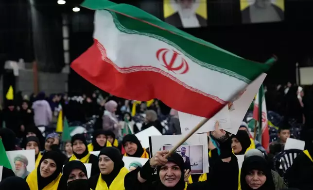 A Hezbollah supporter waves an Iranian flag during a rally to show their solidarity with the Iranian government, in the southern suburb of Beirut, Lebanon, Monday, Jan. 26, 2026. (AP Photo/Hussein Malla)