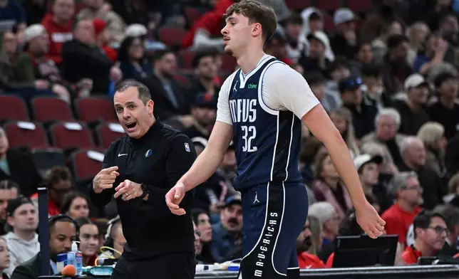 Dallas Mavericks assistant coach Frank Vogel, left, yells to Cooper Flagg (32) during the first half of an NBA basketball game against the Chicago Bulls, Saturday, Jan. 10, 2026, in Chicago. (AP Photo/Paul Beaty)