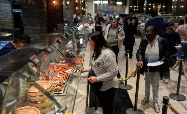 People are served food at the A.Y.C.E Buffet in the Palms resort-casino Wednesday, Jan. 28, 2026, in Las Vegas. (AP Photo/John Locher)