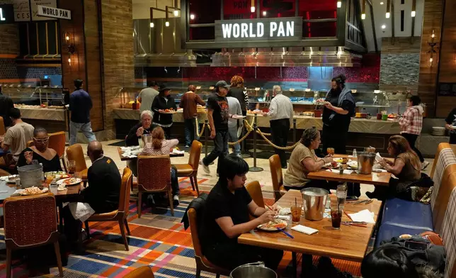 People eat at the A.Y.C.E Buffet in the Palms resort-casino Wednesday, Jan. 28, 2026, in Las Vegas. (AP Photo/John Locher)