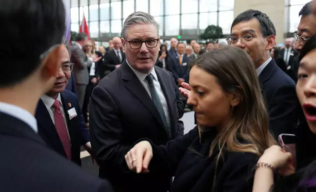 British Prime Minister Keir Starmer, center, arrives for a UK-China Business Forum at the Bank of China in Beijing Friday, Jan. 30, 2026. (Carl Court/Pool Photo via AP)