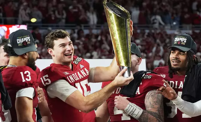 Indiana quarterback Fernando Mendoza holds the trophy after their win against Miami in the College Football Playoff national championship game, Monday, Jan. 19, 2026, in Miami Gardens, Fla. (AP Photo/Marta Lavandier)