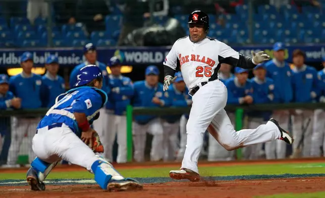 FILE - The Netherlands' designated hitter Andruw Jones (25) tries to dodge Korea's catcher Kang Minho (47) on home plate in the fourth inning of a World Baseball Classic first-round game at the Intercontinental Baseball Stadium in Taichung, Taiwan, March 2, 2013. (AP Photo/Wally Santana, File)