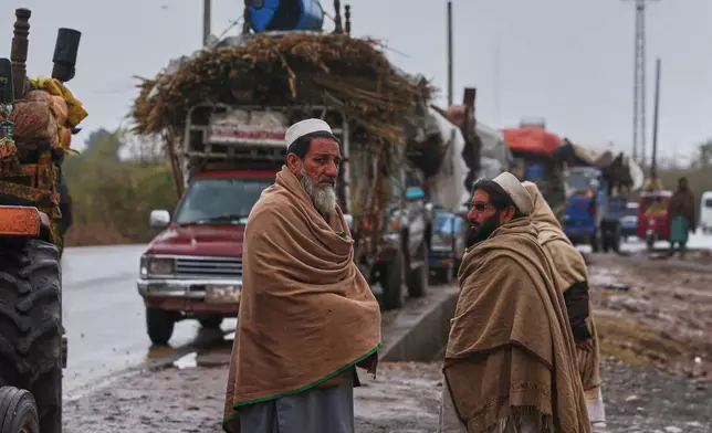 People who fled from Tirah, a town in the Khyber Pakhtunkhwa province, amid uncertainty over a military operation against the Pakistani Taliban, wait for their turn outside a registration center in Bara, a town of Pakistan's northwestern Khyber district, Tuesday, Jan. 27, 2026. (AP Photo/Muhammad Sajjad)