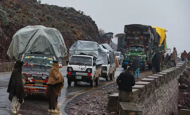 People who fled from Tirah, a town in the Khyber Pakhtunkhwa province, amid uncertainty over a military operation against the Pakistani Taliban, stand beside vehicles loaded with belongings, as they travel to a registration center in Bara, a town of Pakistan's northwestern Khyber district, Tuesday, Jan. 27, 2026. (AP Photo/Muhammad Sajjad)