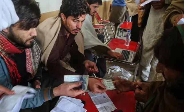 Government workers get information from people, who fled from Tirah, a town in the Khyber Pakhtunkhwa province, amid uncertainty over a military operation against the Pakistani Taliban, at a registration center in Bara, a town of Pakistan's northwestern Khyber district, Tuesday, Jan. 27, 2026. (AP Photo/Muhammad Sajjad)