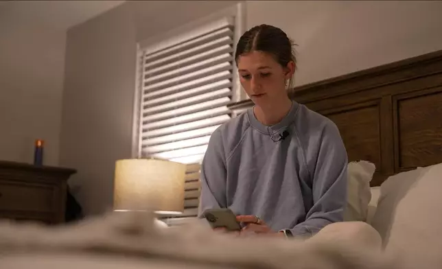 Middle school teacher Kate Stoye checks her sleep score on her phone, Wednesday, Jan. 7, 2026, in Hiram, Ga. (AP Photo/Emilie Megnien)