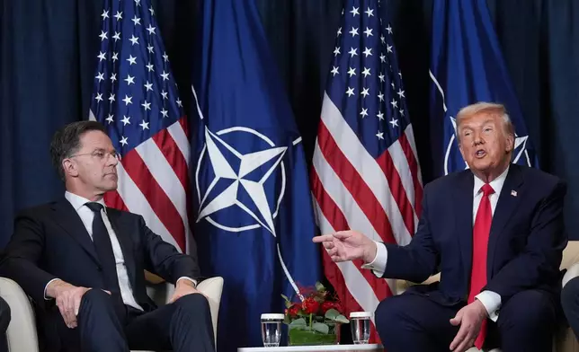 FILE - President Donald Trump, right, meets with NATO Secretary General Mark Rutte on the sidelines of the Annual Meeting of the World Economic Forum in Davos, Switzerland, Jan. 21, 2026. (AP Photo/Evan Vucci, File)