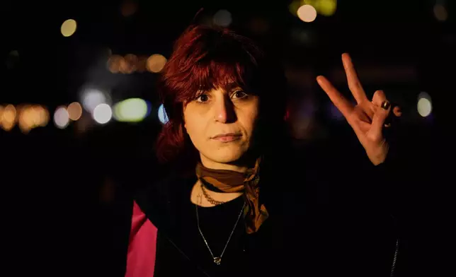 Iranian Maryam Nejatipur 32, poses for a photo after a demonstration in support of the nationwide mass protests in Iran against the government, in Berlin, Germany, Wednesday, Jan. 14, 2026. (AP Photo/Ebrahim Noroozi)