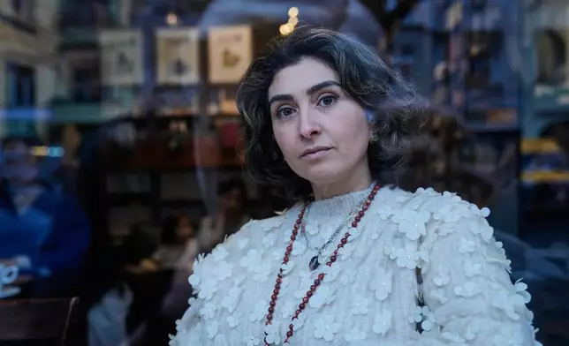 Iranian Mehregan Maroufi poses for a photo before an interview with the Associated Press in her cafe in Berlin, Germany, Thursday, Jan. 15, 2026. (AP Photo/Ebrahim Noroozi)