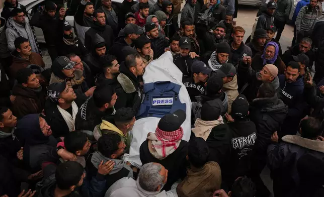 Mourners carry the body of Anas Ghoneim, one of the three Palestinian journalists who were killed in an Israeli strike on an Egyptian committee's vehicle, during his funeral in Khan Younis, southern Gaza Strip, Thursday, Jan. 22, 2026. (AP Photo/Abdel Kareem Hana)