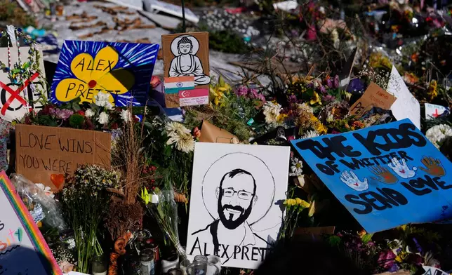 A drawing of Alex Pretti is displayed at the scene where 37-year-old Pretti was fatally shot by a U.S. Border Patrol officer over the weekend, Tuesday, Jan. 27, 2026, in Minneapolis. (AP Photo/Julia Demaree Nikhinson)