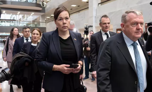From center to right, Greenland Foreign Minister Vivian Motzfeldt, Denmark's Ambassador Jesper Møller Sørensen, rear, and Danish Foreign Minister Lars Løkke Rasmussen, right, arrive on Capitol Hill to meet with senators from the Arctic Caucus, in Washington, Wednesday, Jan. 14, 2026. (AP Photo/J. Scott Applewhite)