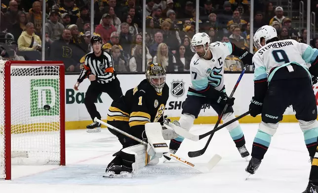 Seattle Kraken's Chandler Stephenson deflects the puck past Boston Bruins goaltender Jeremy Swayman for a goal during the first period of an NHL hockey game, Thursday, Jan. 15, 2026, in Boston. (AP Photo/Winslow Townson)