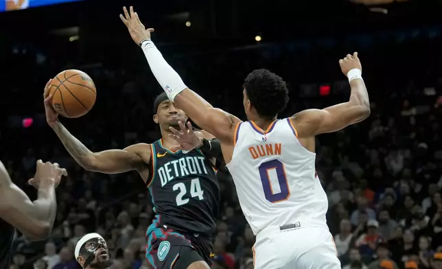 Detroit Pistons guard Daniss Jenkins (24) tries to drive past Phoenix Suns forward Ryan Dunn (0) during the first half of an NBA basketball game Thursday, Jan. 29, 2026, in Phoenix. (AP Photo/Ross D. Franklin)