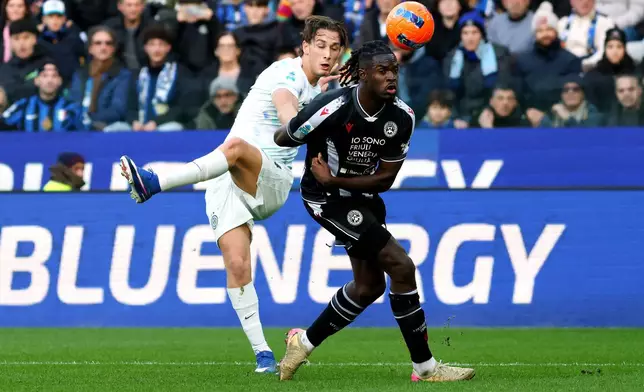 Inter Milan's Francesco Pio Esposito, left, kicks the ball past Udinese's Oumar Solet during the Serie A soccer match between Udinese and Inter, in Udine, Italy, Saturday, Jan. 17, 2026. (Andrea Bressanutti/LaPresse via AP)