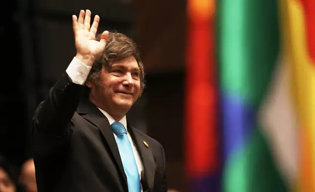FILE - Argentina's President Javier Milei waves as he attends the swearing-in ceremony of President Rodrigo Paz in La Paz, Bolivia, Nov. 8, 2025. (Luis Gandarillas/Pool Photo via AP, File)