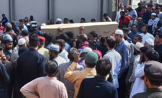 People carry the coffin of Shahroz Iqbal, who was killed in the shopping mall fire incident, during his funeral in Karachi, Pakistan, Wednesday, Jan. 21, 2026. (AP Photo/Ali Raza)