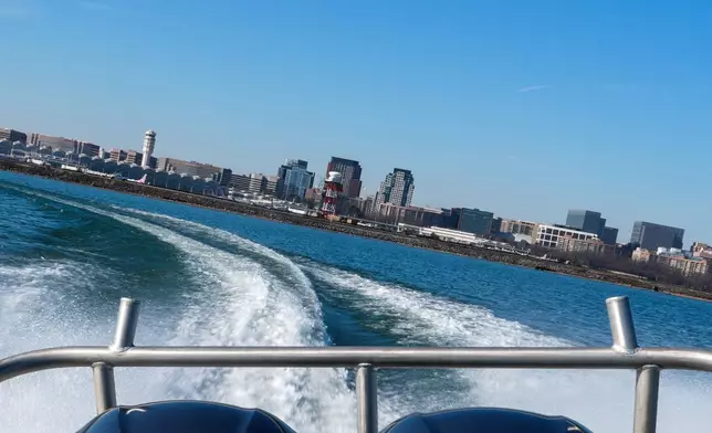 Ronald Reagan Washington National Airport is seen as Metropolitan Police Department diver Jeffrey Leslie pilots a boat along the Potomac River, Thursday, Jan. 22, 2026, in Washington. (AP Photo/Julia Demaree Nikhinson)