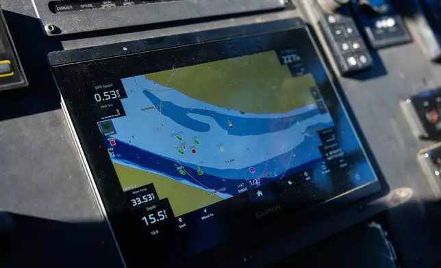 Locations of debris from the collision of American Airlines Flight 5342 and an Army helicopter are displayed on the GPS screen as Metropolitan Police Department diver Jeffrey Leslie pilots a boat along the Potomac River, Thursday, Jan. 22, 2026, in Washington. (AP Photo/Julia Demaree Nikhinson)