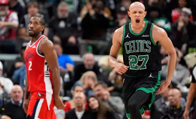 Boston Celtics guard Jordan Walsh, right, celebrates after scoring as Los Angeles Clippers forward Kawhi Leonard watches during the second half of an NBA basketball game Saturday, Jan. 3, 2026, in Inglewood, Calif. (AP Photo/Mark J. Terrill)
