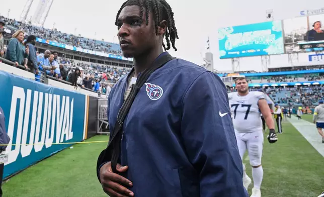 Tennessee Titans quarterback Cam Ward leaves the field after the team's loss in an NFL football game against the Jacksonville Jaguars, Sunday, Jan. 4, 2026, in Jacksonville, Fla. (AP Photo/Phelan M. Ebenhack)