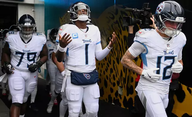 Tennessee Titans quarterback Cam Ward (1) walks out of the tunnel on to the field before an NFL football game against the Jacksonville Jaguars, Sunday, Jan. 4, 2026, in Jacksonville, Fla. (AP Photo/Phelan M. Ebenhack)