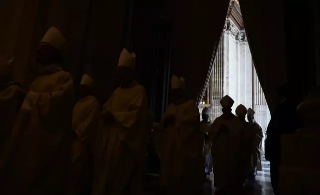 Members of the clergy arrive ahead of Pope Leo XIV for the closing of the Holy Door of St. Peter's Basilica to end the 2025 ordinary Jubilee year, at the Vatican, Tuesday, Jan. 6, 2026. (Yara Nardi/Pool photo via AP)