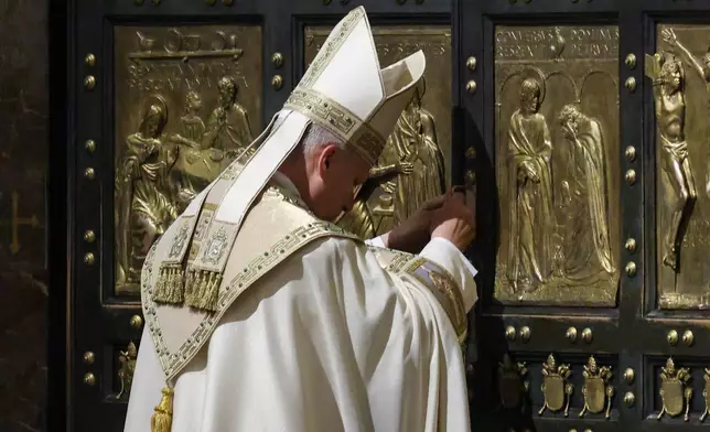 Pope Leo XIV closes St. Peter's Basilica Holy Door to end the 2025 ordinary Jubilee year, at the Vatican, Tuesday, Jan. 6, 2025. (Yara Nardi/Pool photo via AP)